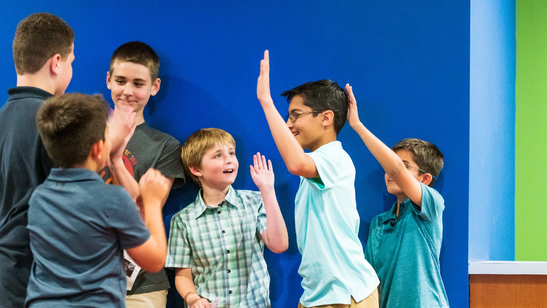 A group of kids high-fiving at Brookwood Church on Sunday